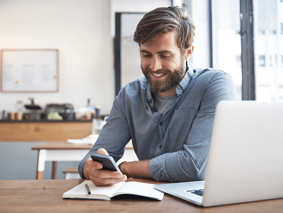 man_phone_notebook_laptop_desk