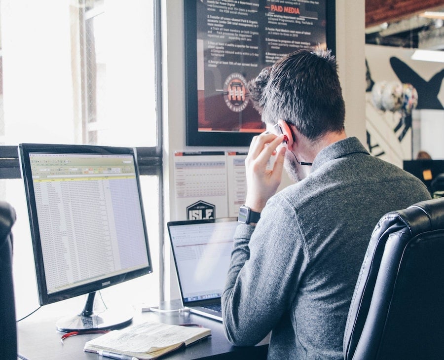 Man working at computer with headphones