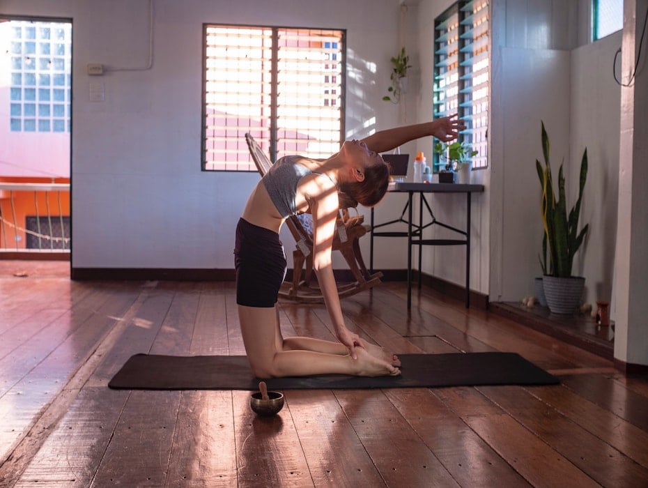 Woman practicing yoga at home