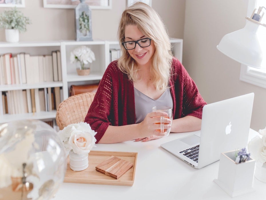 Woman working from home in red sweater