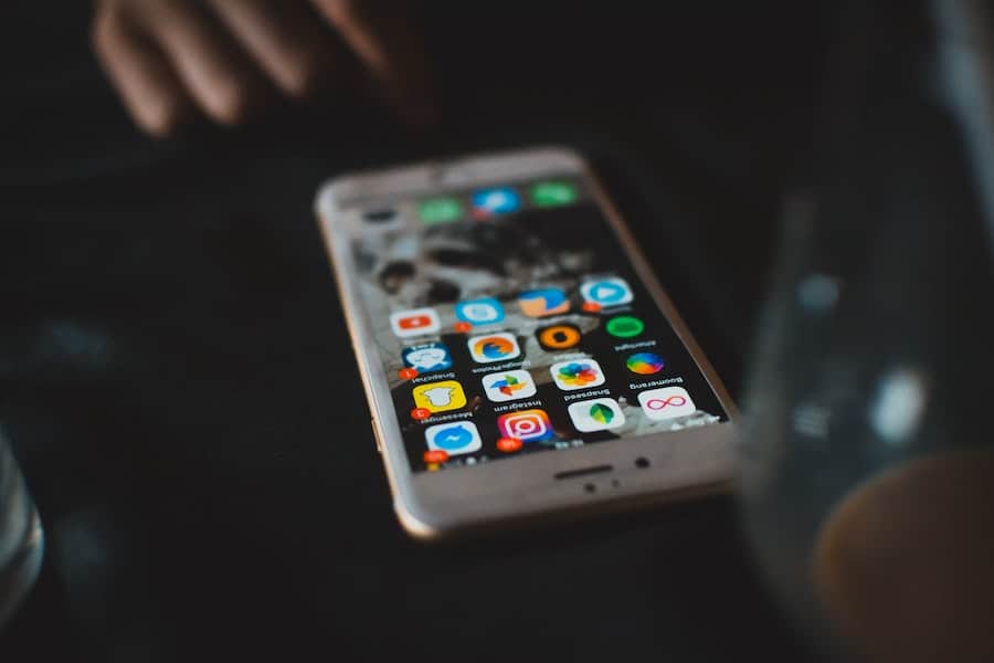 iPhone on table with social media apps on home screen