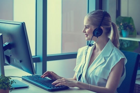 Woman typing on a computer keyboard