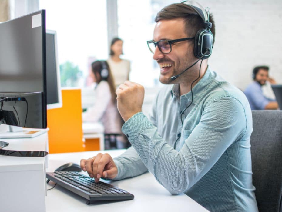 Technical support operator working with headset in call center office