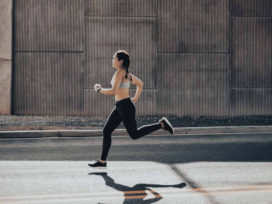 Female runner on city road.