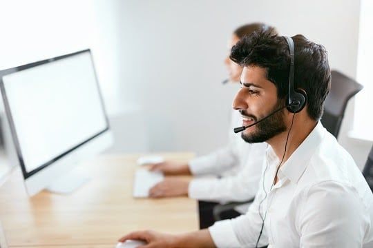 Wearing a headset at a desk