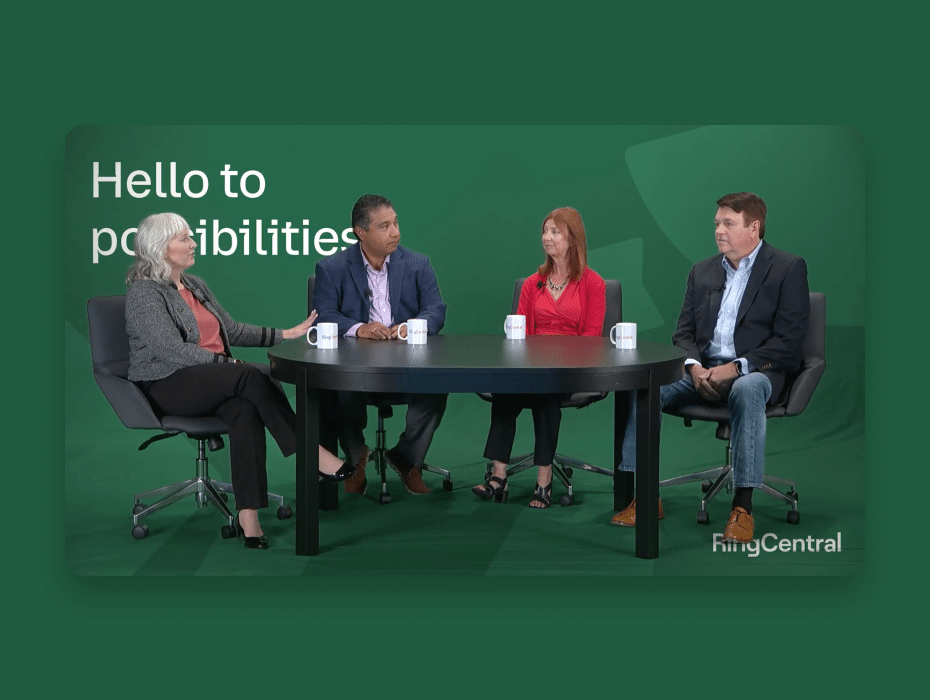 4 people sitting around a round table chatting with green background