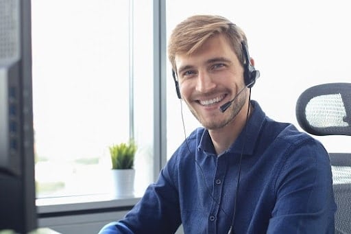 Smiling friendly handsome young male call centre operator