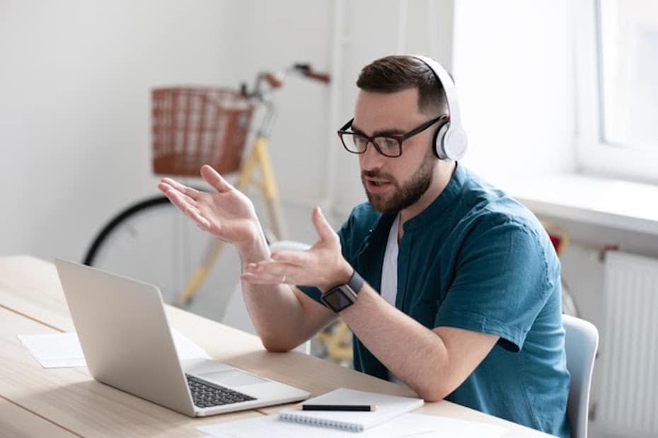 Financial services employee with headset and laptop working remotely