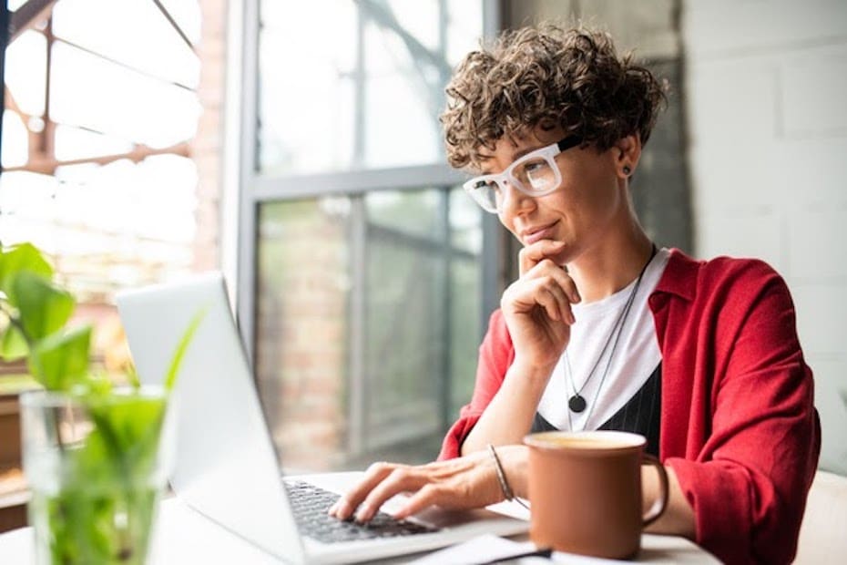 Financial services professional working on laptop while meeting regulatory requirements hybrid work environment