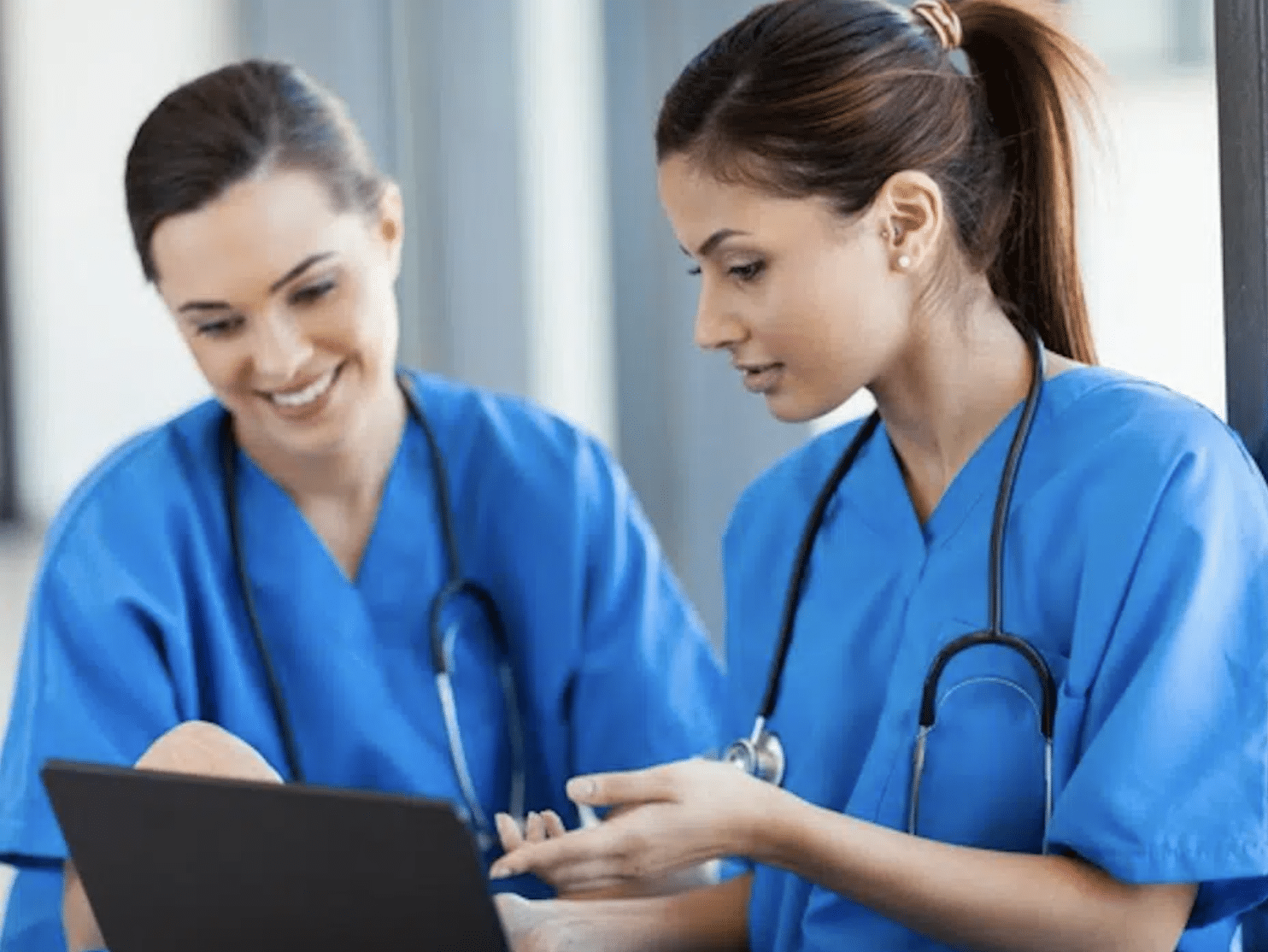 Two female healthcare practitioners with a tablet.