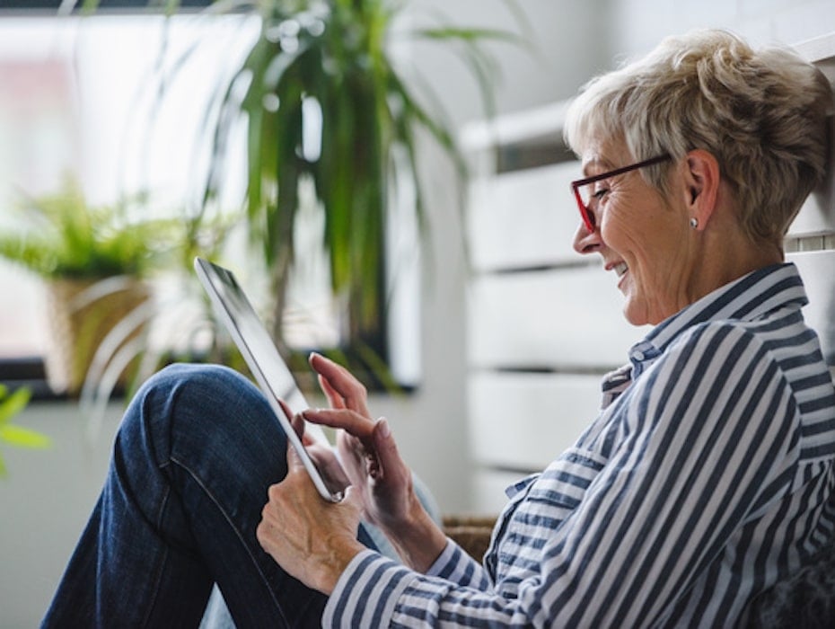 Senior woman using digital tablet at home. The use of technology by the elderly.