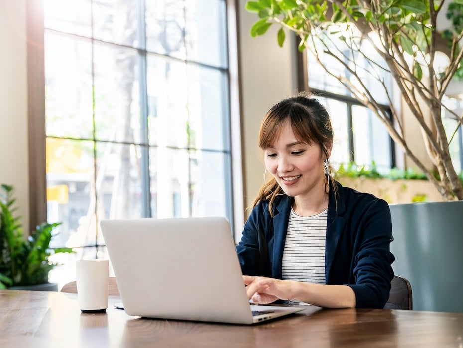 Business person working at office desk showing employee happiness