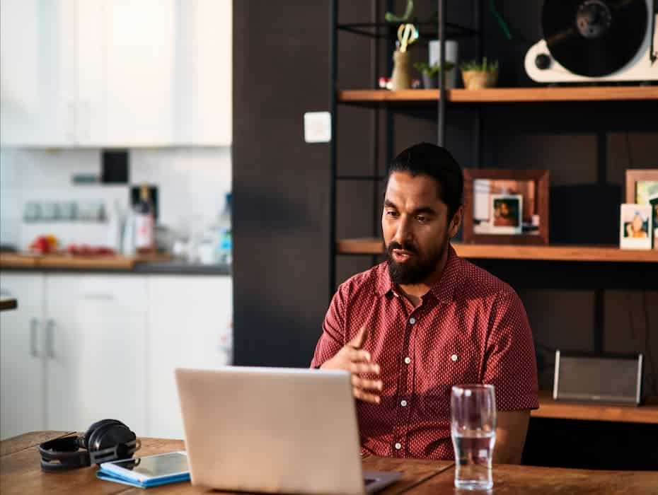 Man is working from home speaking on a video call.