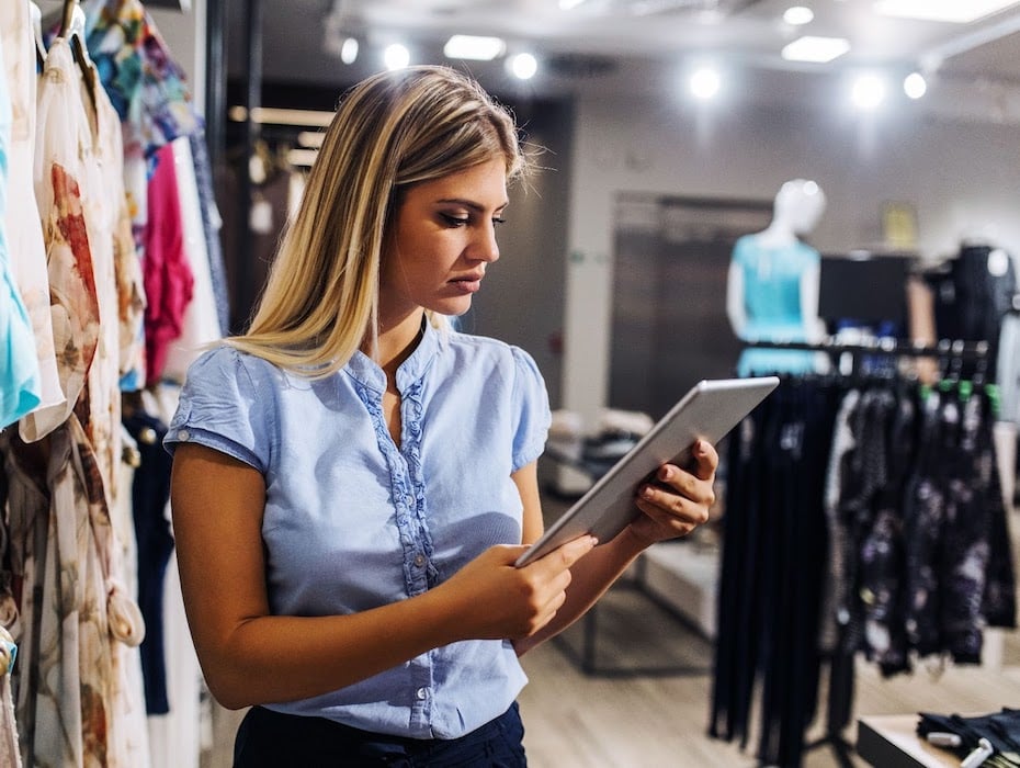 Retail employee holds tablet in store