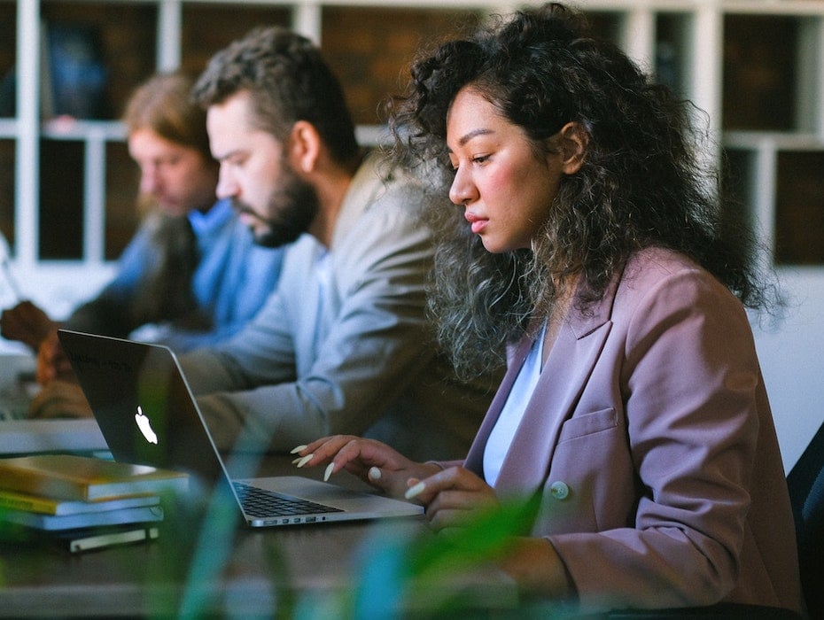 Government agency employees work on their laptops