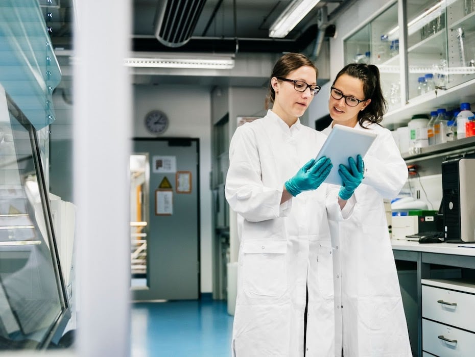 Two researchers ponder over something in a lab setting