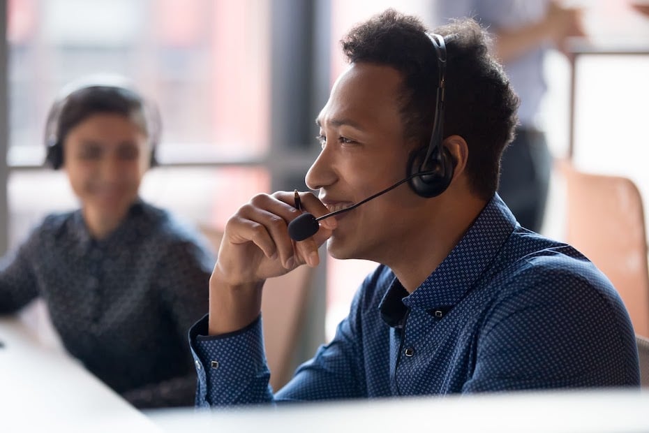 A customer service agent wears a headset while helping P&C Insurance clients.