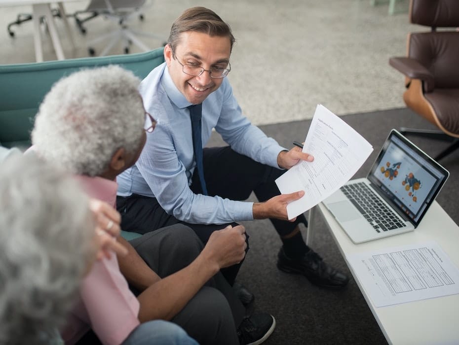 Clients sit with a P&C Insurance employee in front of a computer