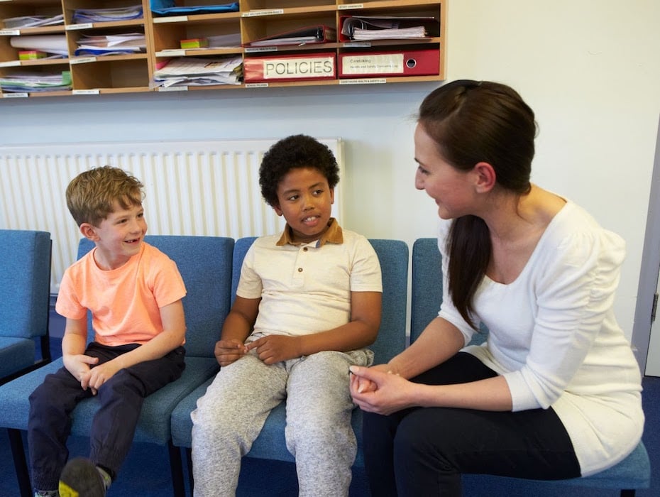 A teacher soliciting the opinions of two students.