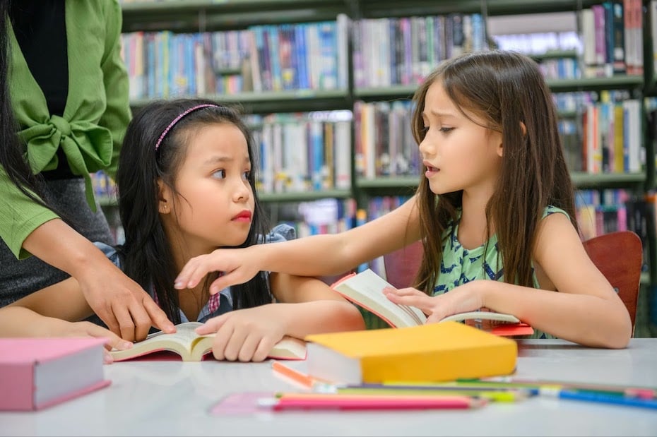 Two young students arguing in a classroom setting.