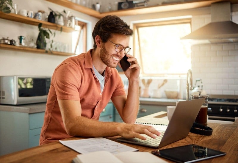 remote working speaking on his phone at home