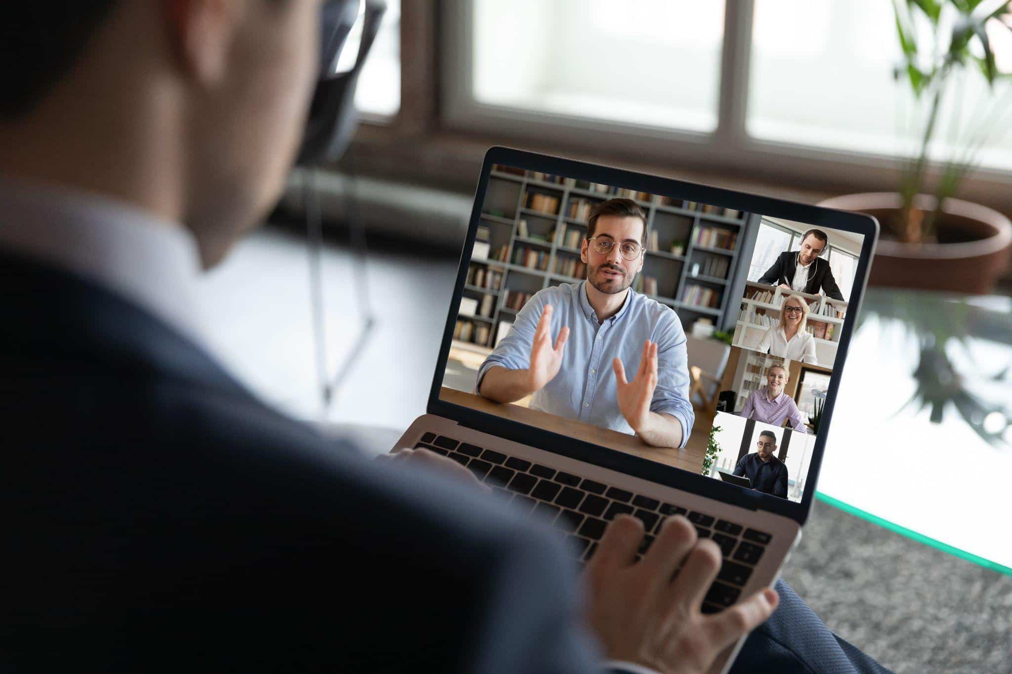 viewing a virtual event on a laptop at home