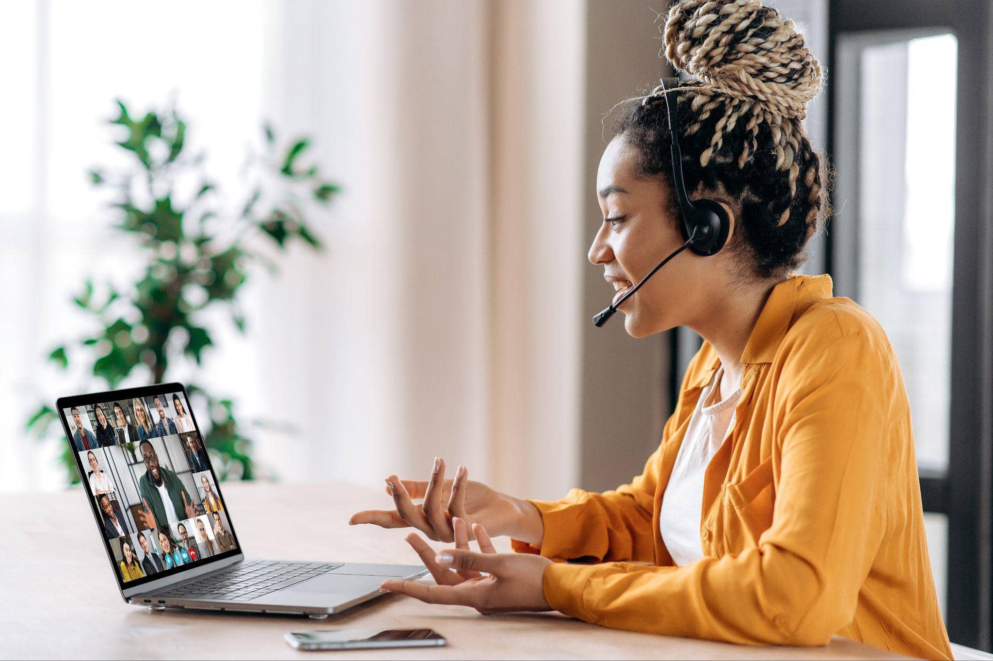 woman in headset facilitating virtual meeting with remote team, showcasing virtual meeting room technology