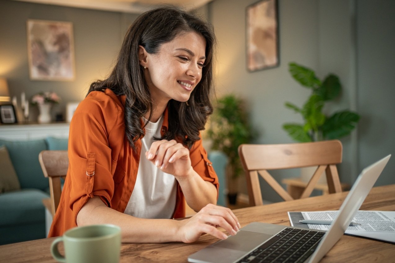 woman using top omnichannel communications solutions on her laptop in a home office setting