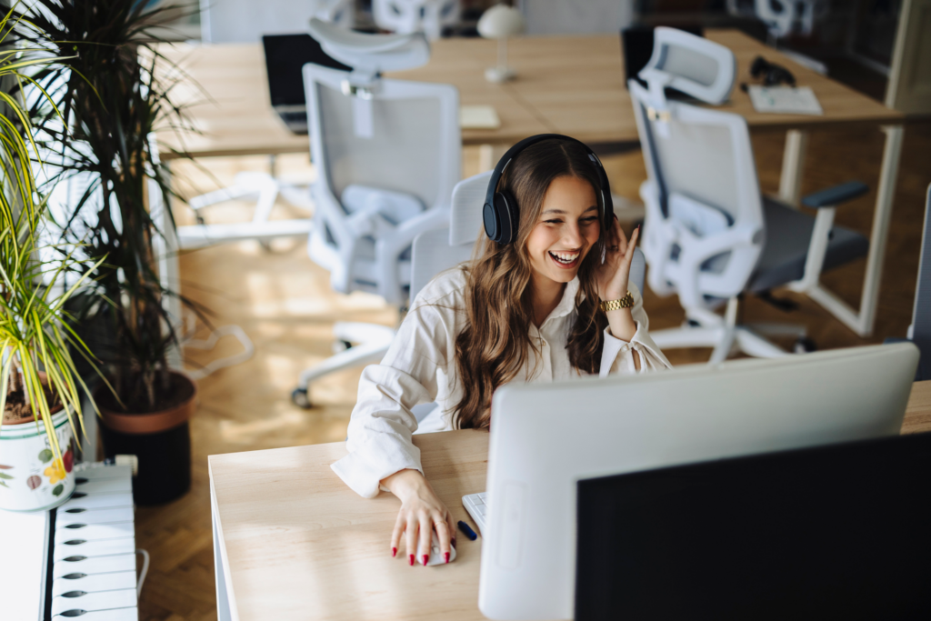 A female contact center manager coaching an agent during a live call